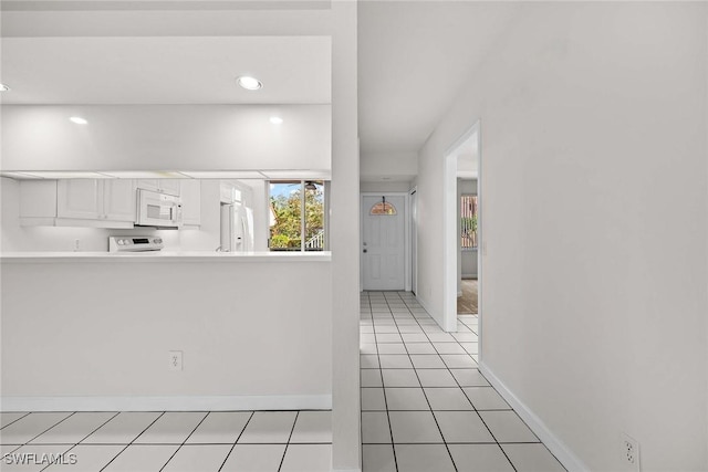 interior space featuring light tile patterned floors and baseboards