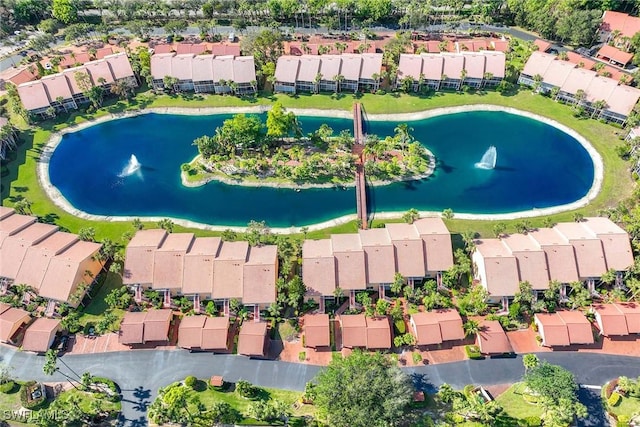 drone / aerial view with a water view and a residential view