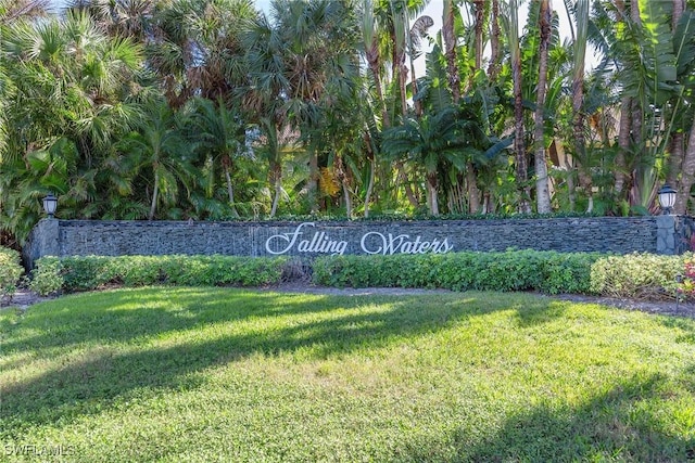 community / neighborhood sign with a lawn