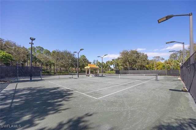 view of sport court featuring fence