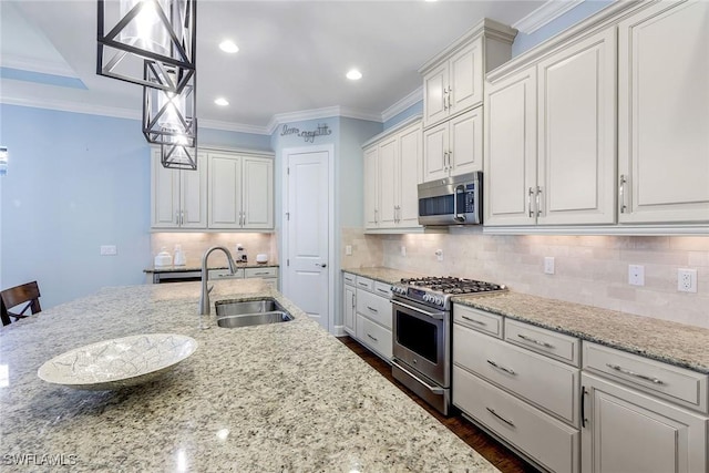 kitchen featuring white cabinetry, sink, pendant lighting, and appliances with stainless steel finishes