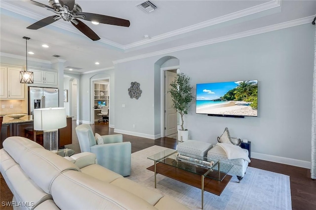 living room featuring ceiling fan, dark wood-type flooring, and ornamental molding