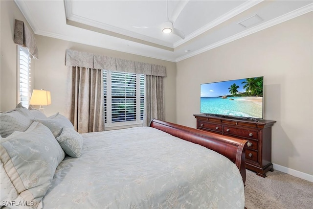 carpeted bedroom with ceiling fan, a raised ceiling, and crown molding