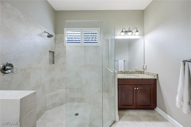 bathroom featuring vanity and tiled shower