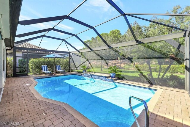 view of swimming pool featuring glass enclosure and a patio area