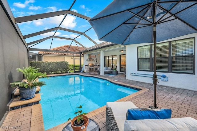 view of pool with ceiling fan, a lanai, and a patio