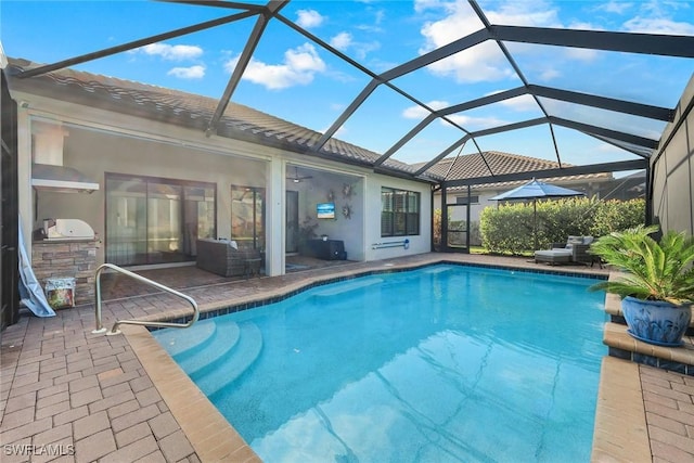 view of swimming pool with a patio and glass enclosure