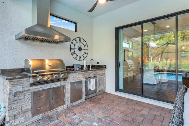 view of patio with area for grilling, sink, and exterior kitchen