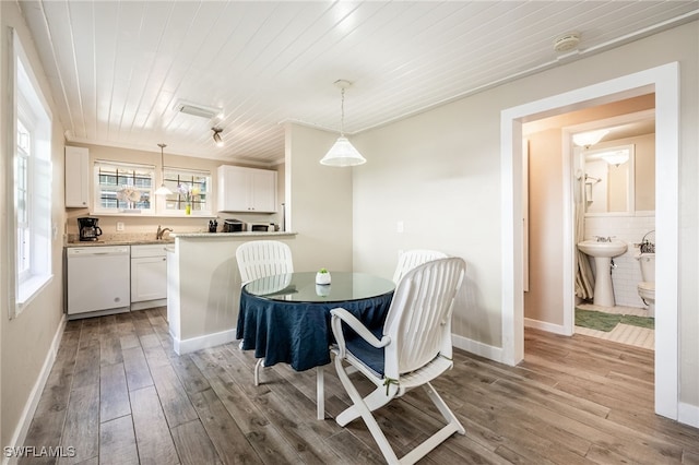 dining space featuring wooden ceiling, sink, and light wood-type flooring