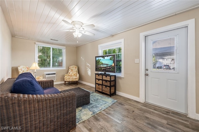 living room featuring a healthy amount of sunlight, wood ceiling, wood finished floors, and a wall mounted AC