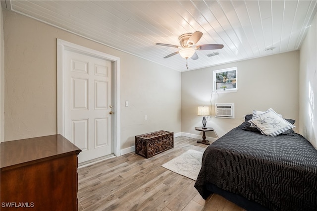 bedroom featuring wood ceiling, a wall unit AC, ceiling fan, and light hardwood / wood-style flooring