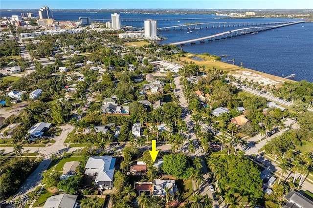 birds eye view of property with a water view and a view of city