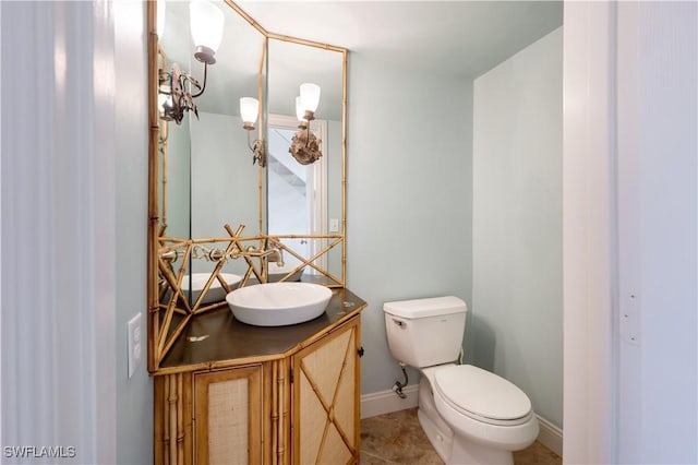 bathroom with tile patterned flooring, vanity, and toilet