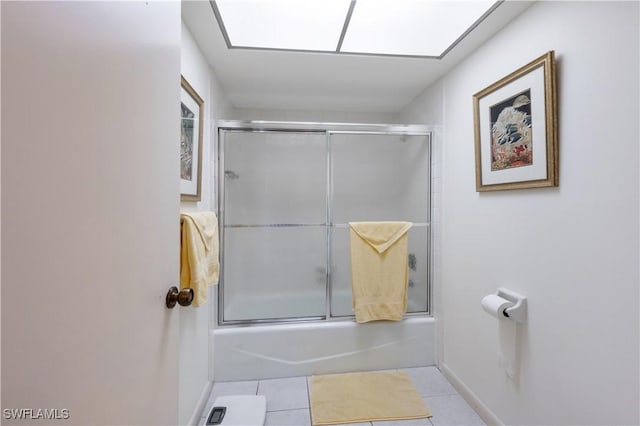 bathroom featuring tile patterned flooring and shower / bath combination with glass door