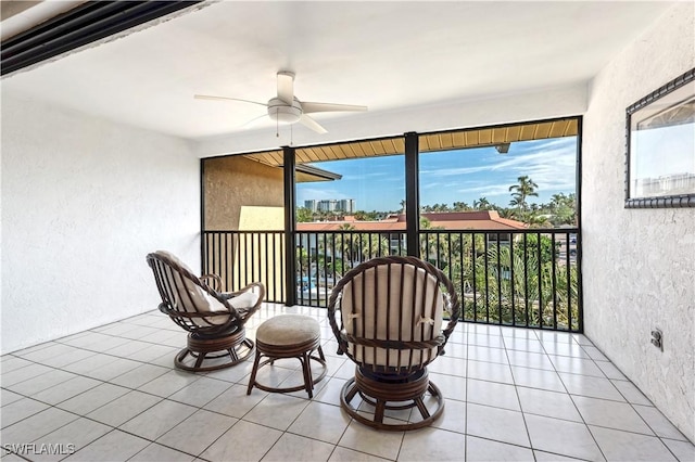 sunroom featuring ceiling fan