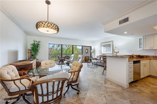 tiled dining area featuring ornamental molding