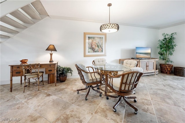 dining space with crown molding