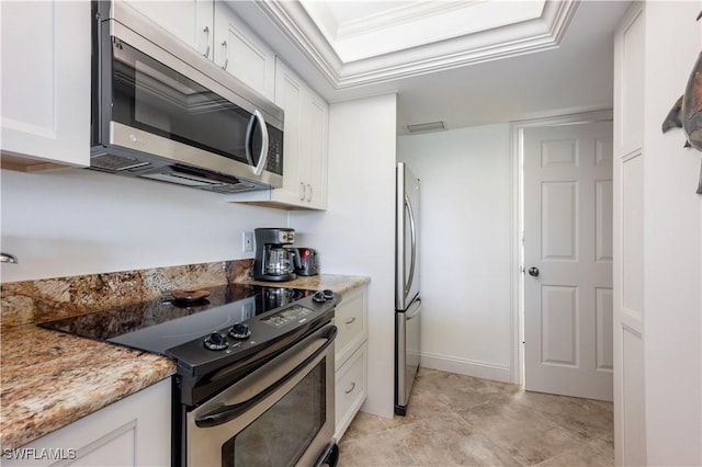 kitchen featuring light stone countertops, white cabinetry, and stainless steel appliances