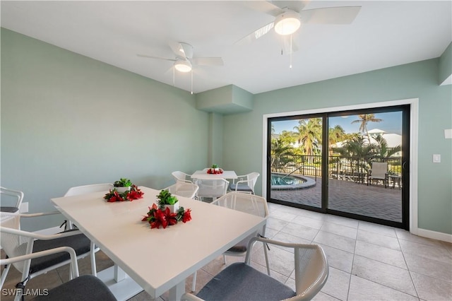 tiled dining room featuring ceiling fan