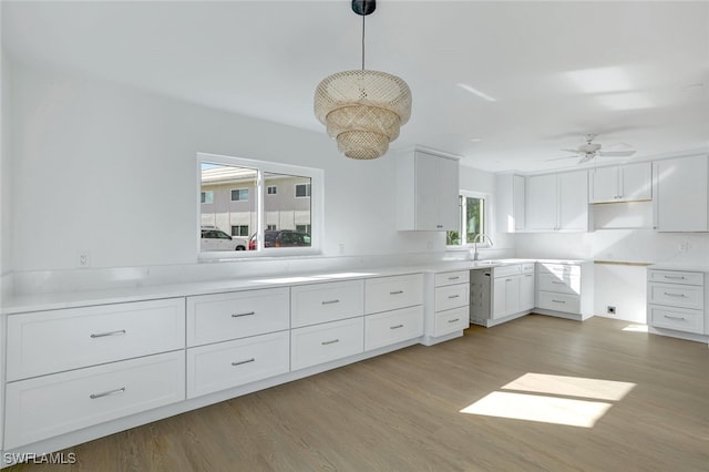 kitchen featuring pendant lighting, plenty of natural light, and white cabinetry