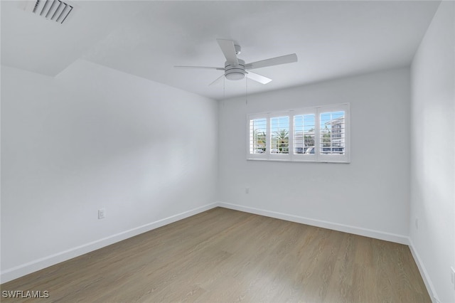 spare room with ceiling fan and light wood-type flooring