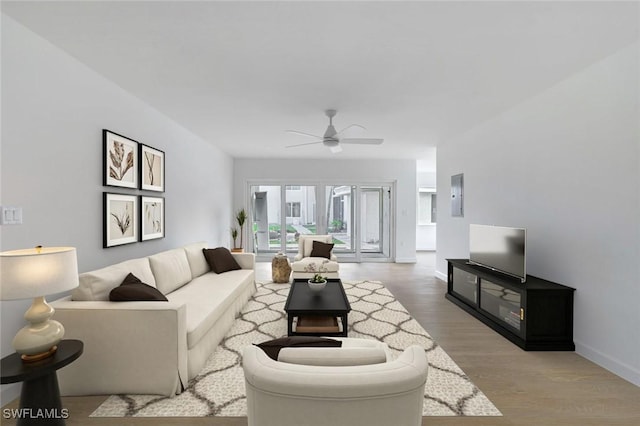 living room featuring wood-type flooring, electric panel, and ceiling fan