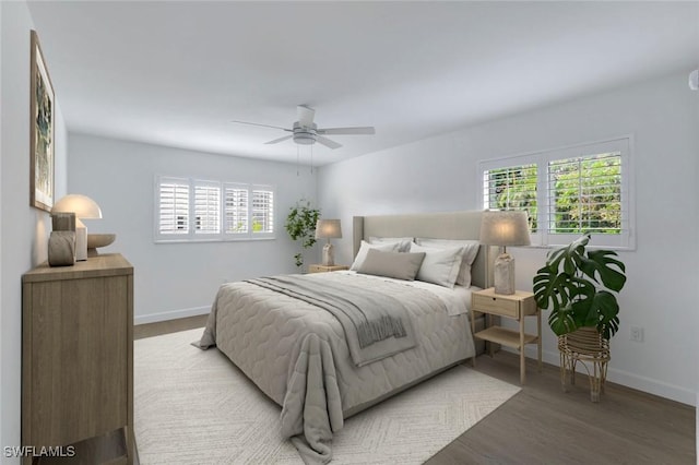 bedroom with multiple windows, ceiling fan, and wood-type flooring