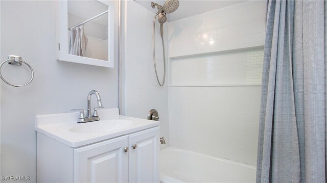 bathroom featuring vanity and shower / bath combination with curtain