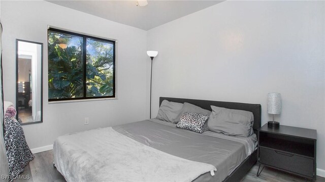 bedroom with wood-type flooring