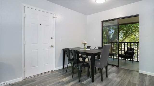 dining area with dark hardwood / wood-style flooring