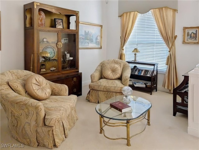 sitting room with a wealth of natural light and carpet