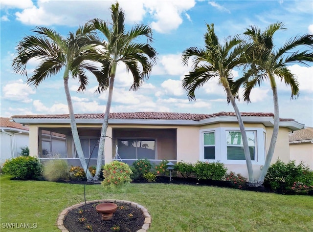 view of front of property with stucco siding and a front lawn