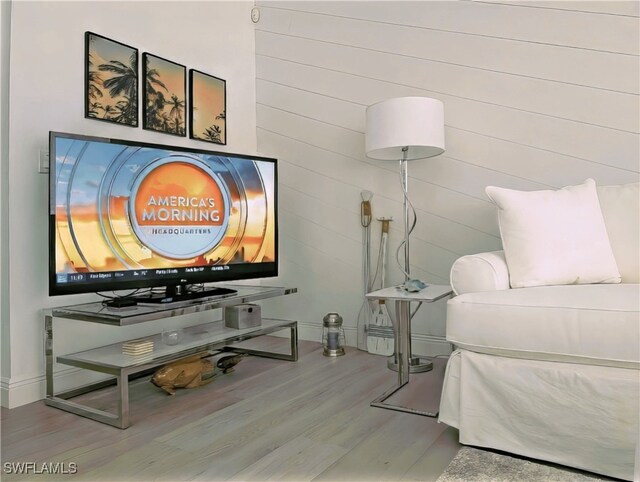 bedroom featuring baseboards and wood finished floors