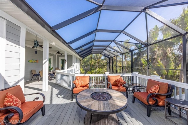 deck with outdoor lounge area, ceiling fan, and a lanai