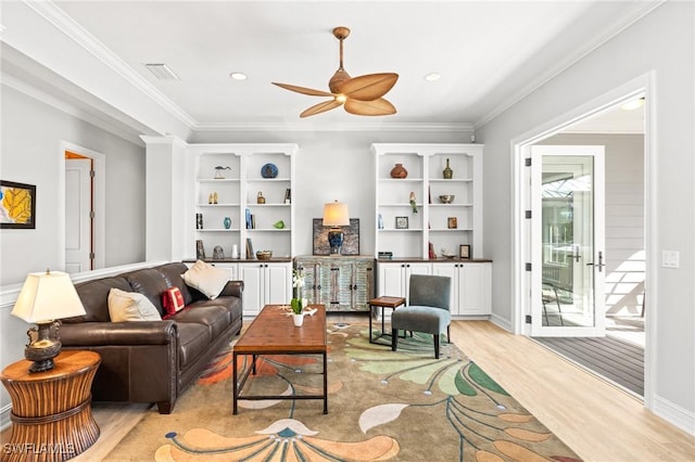 living room with ceiling fan, light hardwood / wood-style floors, and crown molding