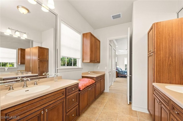 bathroom with tile patterned flooring and vanity