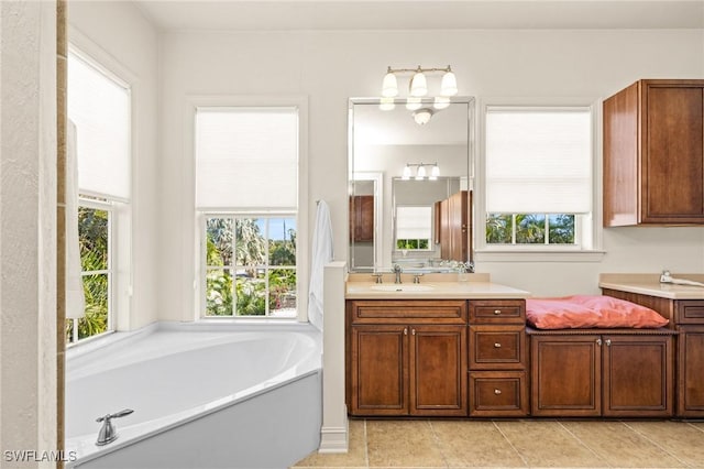 bathroom with vanity, tile patterned floors, and a bathing tub