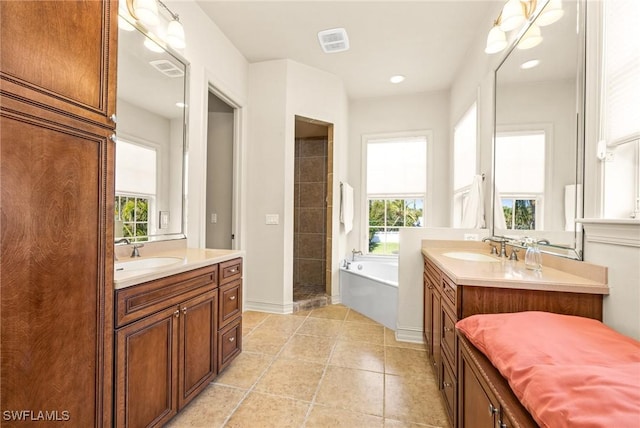 bathroom featuring tile patterned flooring, vanity, and a healthy amount of sunlight