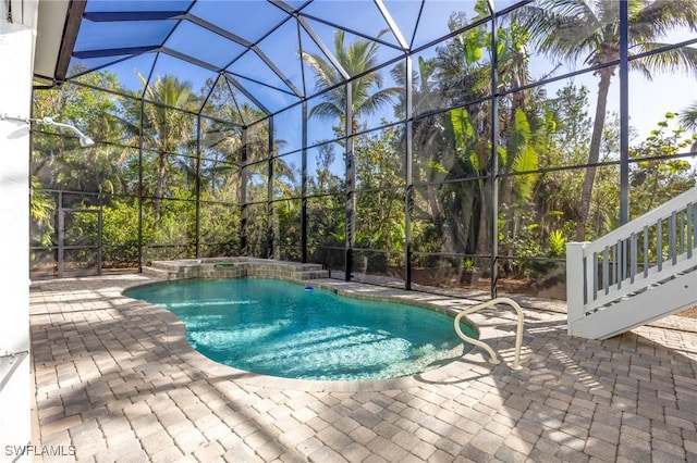 view of pool featuring a patio area and glass enclosure