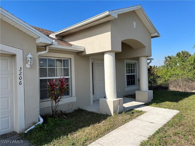 property entrance with a yard