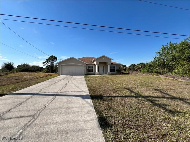 view of front of property with a front yard and a garage