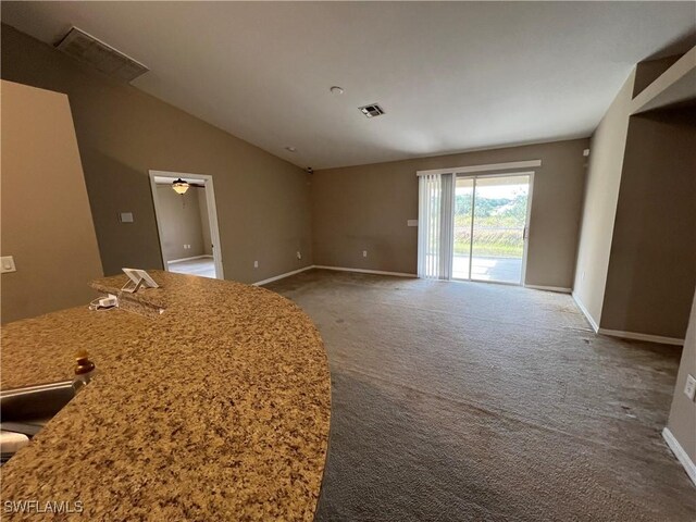 interior space featuring ceiling fan and lofted ceiling