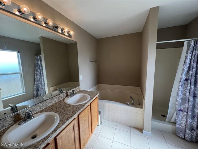 bathroom featuring tile patterned flooring, separate shower and tub, and vanity