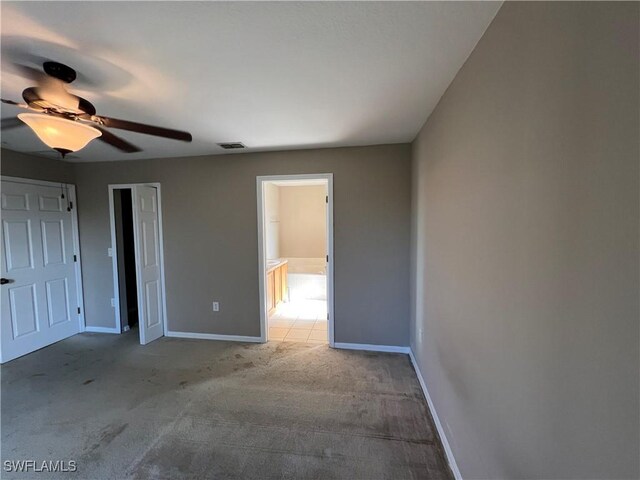 unfurnished bedroom featuring ceiling fan and light colored carpet