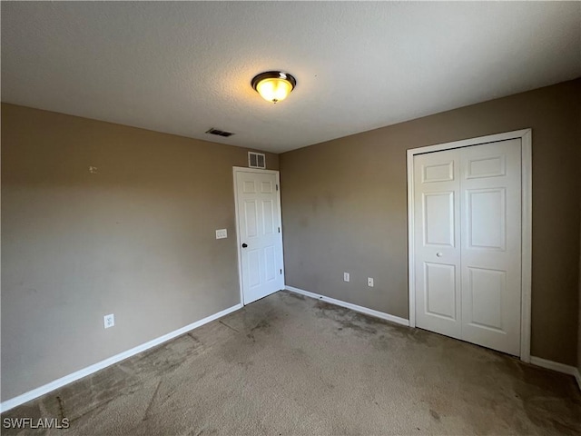 unfurnished bedroom featuring carpet and a closet