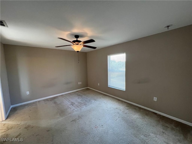 empty room with ceiling fan and carpet