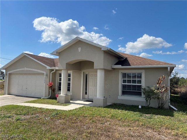 view of front of house with a garage and a front lawn