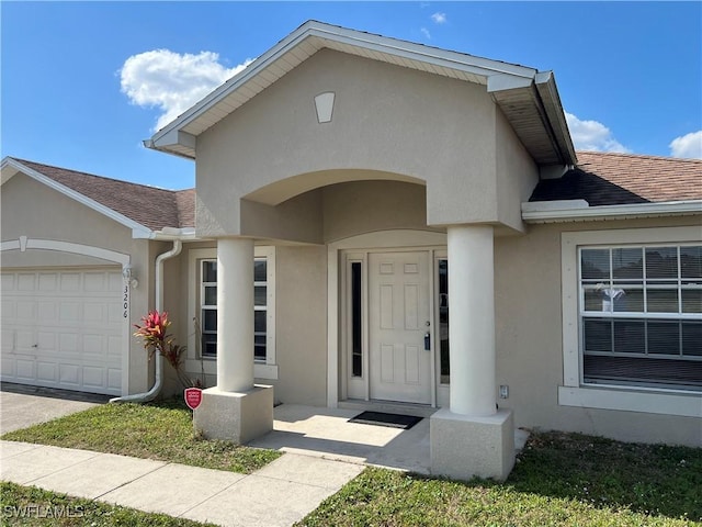 view of exterior entry with a garage