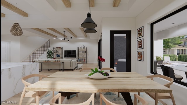 dining area featuring beam ceiling