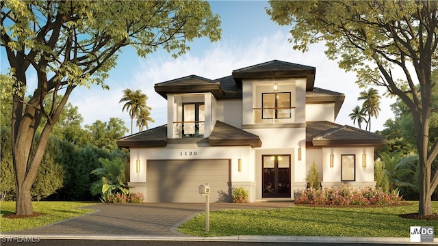 view of front of property featuring a garage, french doors, and a front lawn